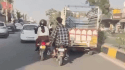 the clip appears to show one of the men inappropriately touching the woman while she was riding a two wheeler on the road