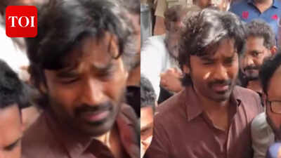 dhanush looks visibly shaken and consoles close friend shanthanu bhagyaraj while paying last respects to director k watch